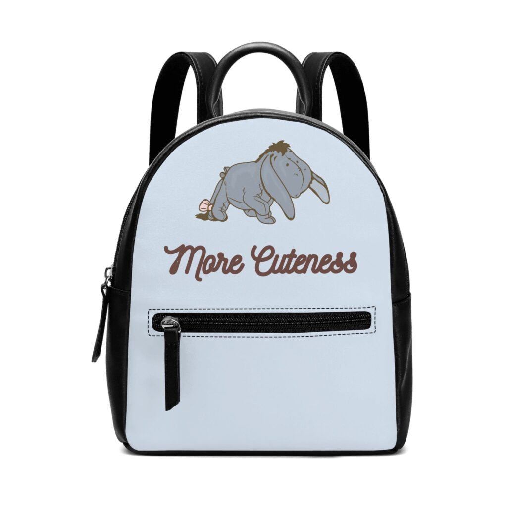 Eeyore on a mini vegan leather backpack with the words More Cuteness below